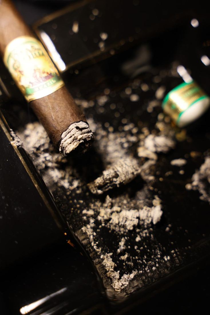 Un cigarro descansando en el cenicero