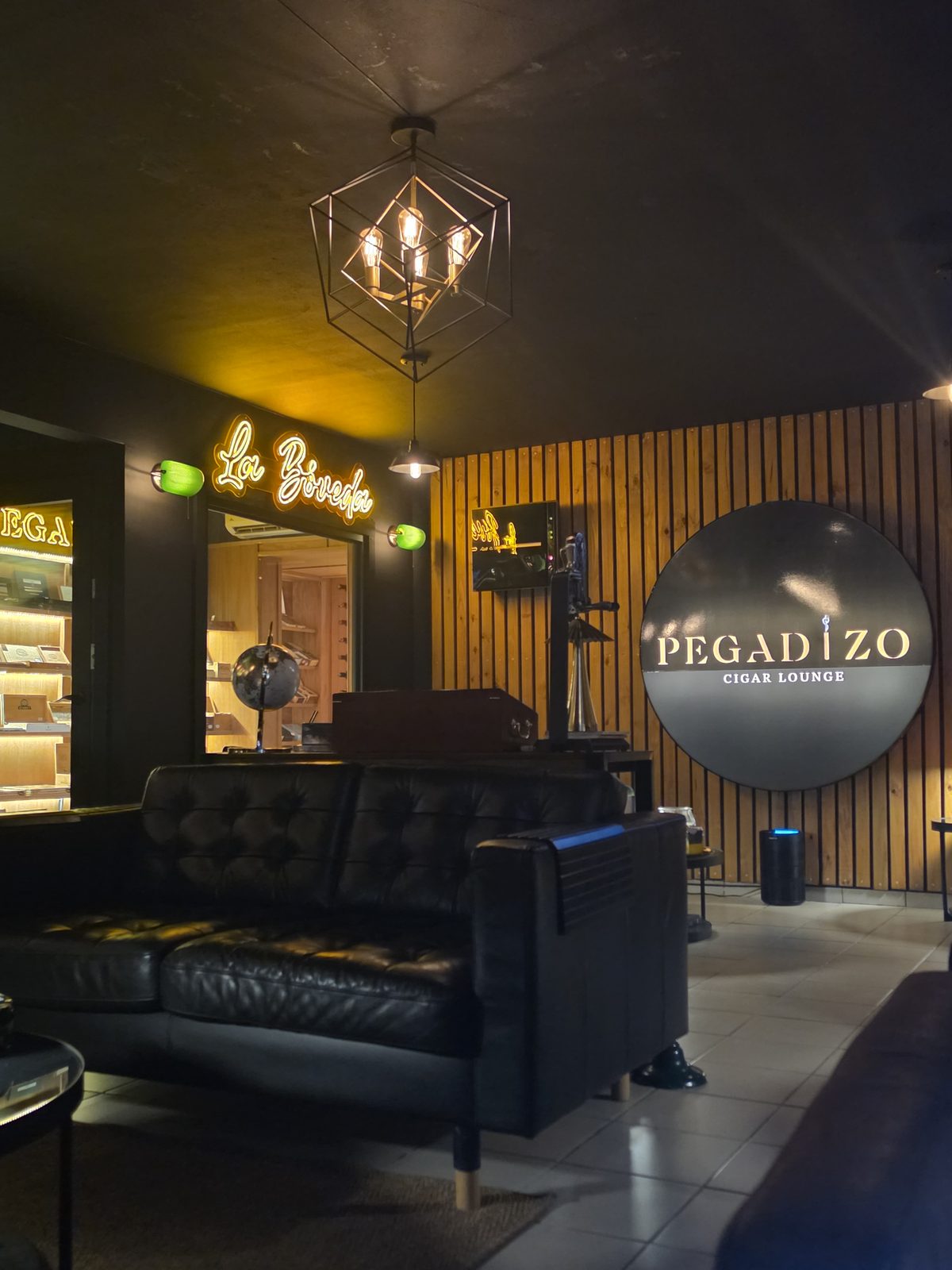 El letrero de neón La Bóveda sobre la puerta del humidor de cedro